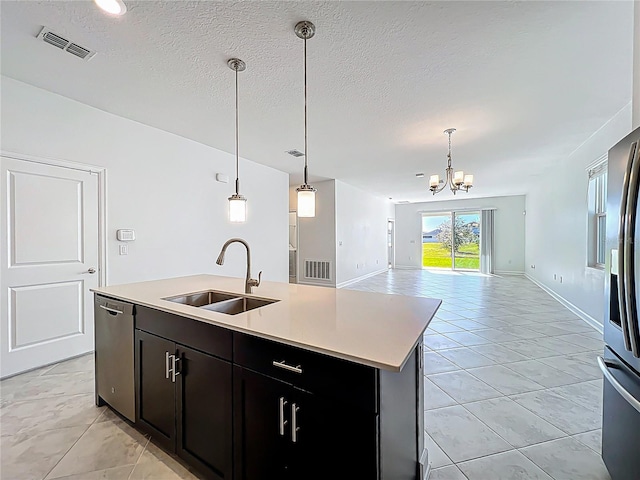 kitchen featuring a sink, open floor plan, visible vents, and stainless steel appliances