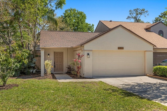 ranch-style home featuring a front yard, an attached garage, a shingled roof, stucco siding, and concrete driveway