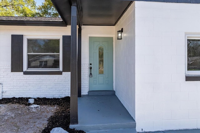 property entrance with concrete block siding