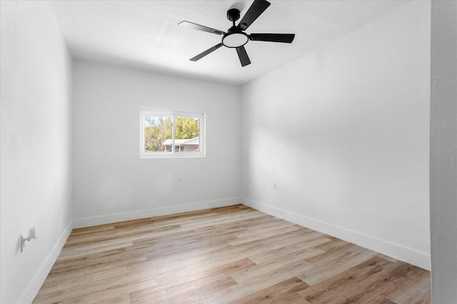 empty room featuring ceiling fan, baseboards, and light wood-style flooring