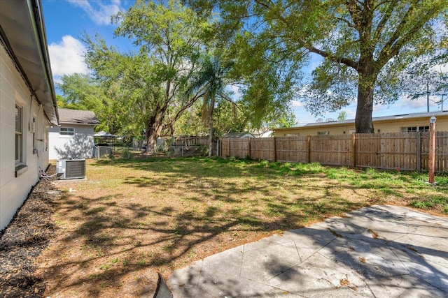 view of yard with a patio, central AC unit, and a fenced backyard