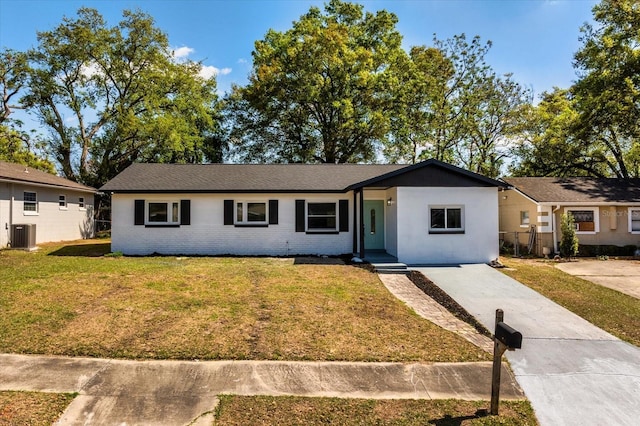 ranch-style house with a front yard, fence, driveway, central air condition unit, and brick siding