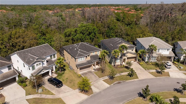 drone / aerial view featuring a view of trees and a residential view