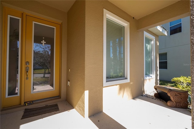property entrance featuring stucco siding