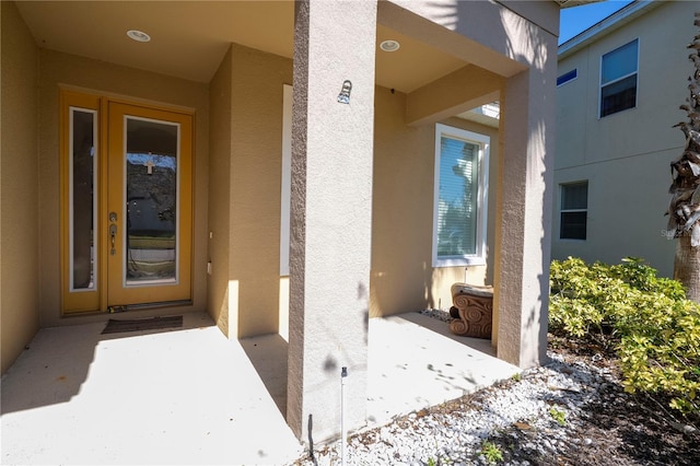 entrance to property with stucco siding