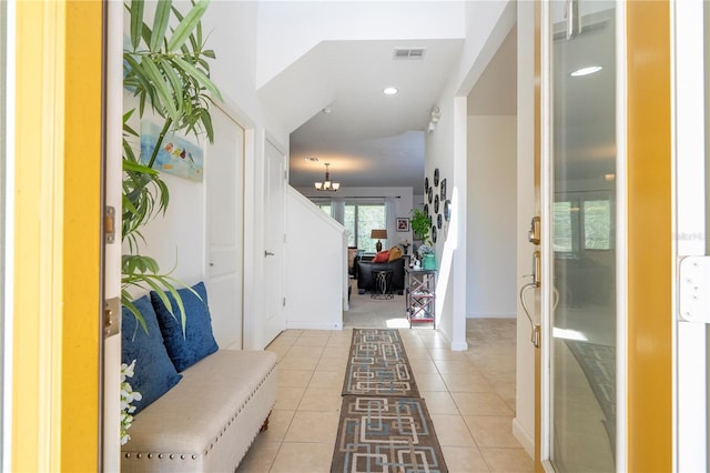 foyer entrance with light tile patterned floors, baseboards, visible vents, recessed lighting, and a chandelier