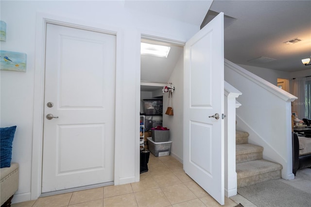 interior space with tile patterned floors and visible vents