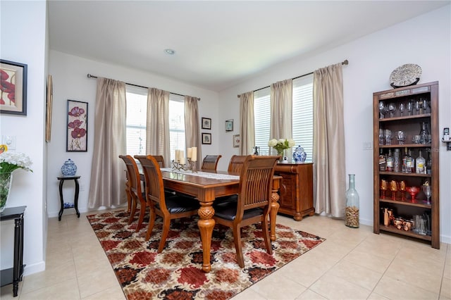 dining room featuring light tile patterned floors and baseboards