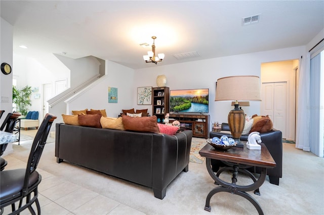 living area with stairs, a notable chandelier, light tile patterned flooring, and visible vents