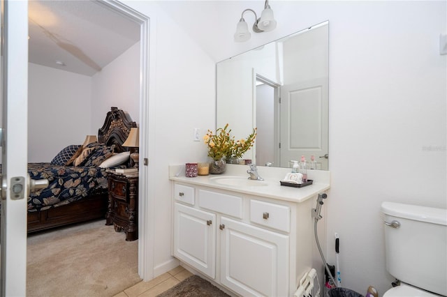 bathroom featuring tile patterned flooring, toilet, vanity, and connected bathroom