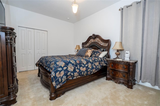 bedroom featuring a closet and light carpet