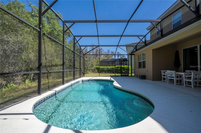 outdoor pool with a lanai, outdoor dining area, and a patio