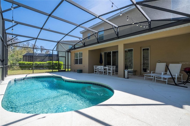 pool with glass enclosure and a patio