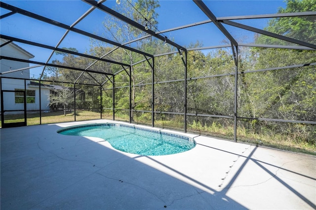 outdoor pool featuring a lanai and a patio