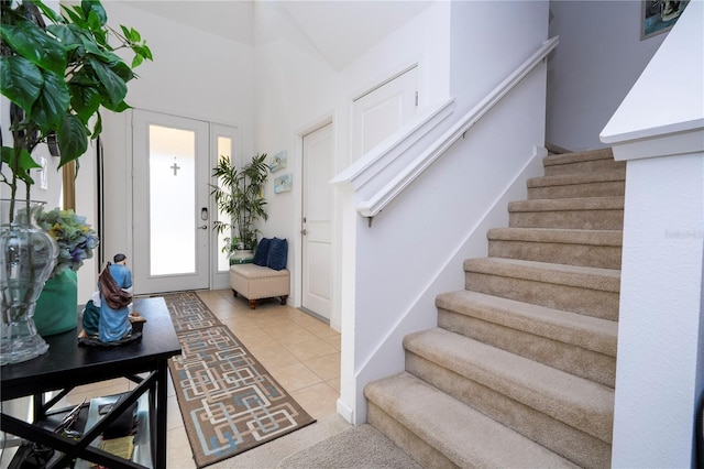 foyer featuring stairway and light tile patterned flooring