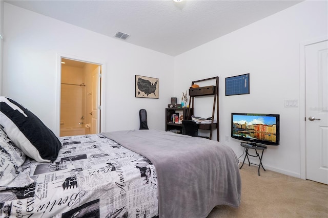 carpeted bedroom featuring visible vents, baseboards, and connected bathroom