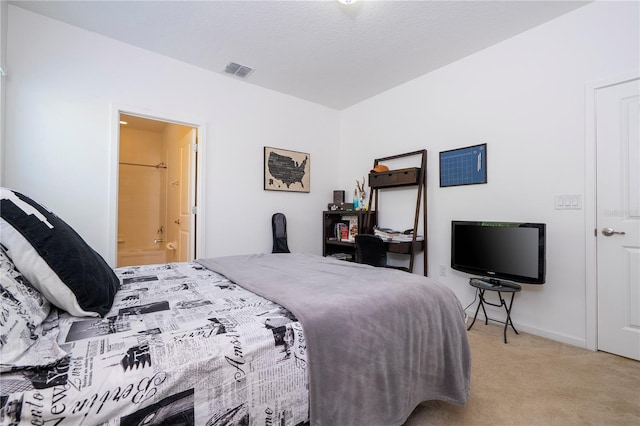 carpeted bedroom featuring visible vents, connected bathroom, and baseboards
