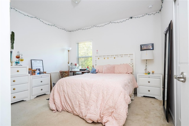 bedroom featuring light colored carpet