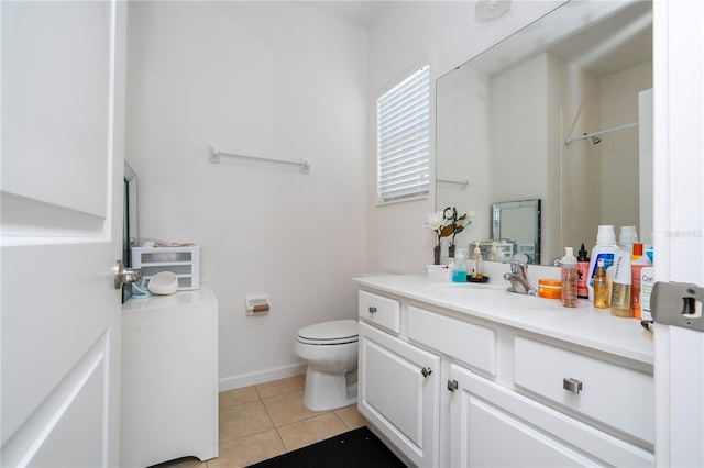 bathroom with tile patterned flooring, baseboards, toilet, vanity, and a shower