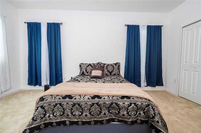carpeted bedroom with baseboards