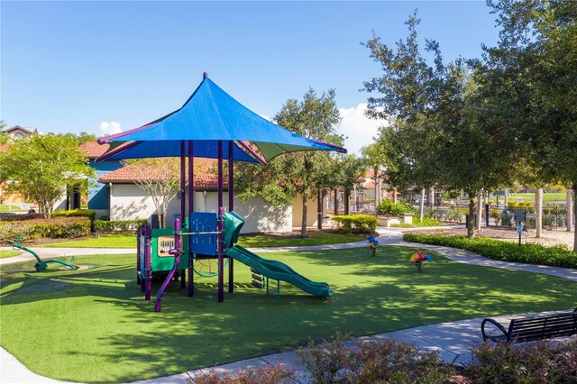 communal playground featuring a lawn