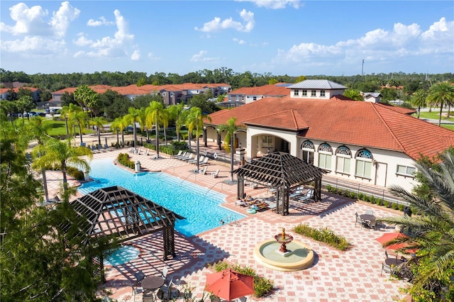 pool with a gazebo, a patio area, and fence