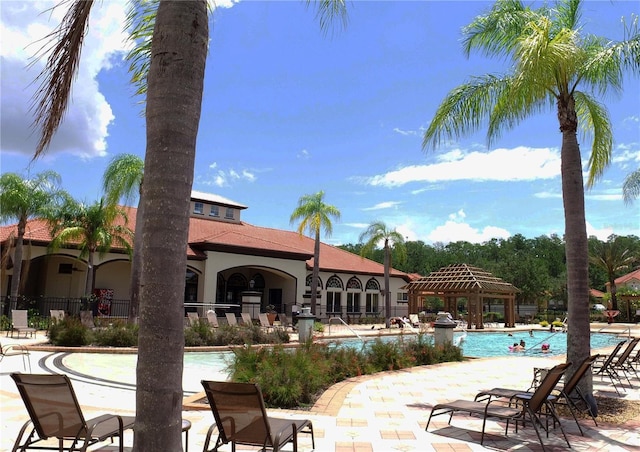 pool featuring a gazebo, a patio area, and fence