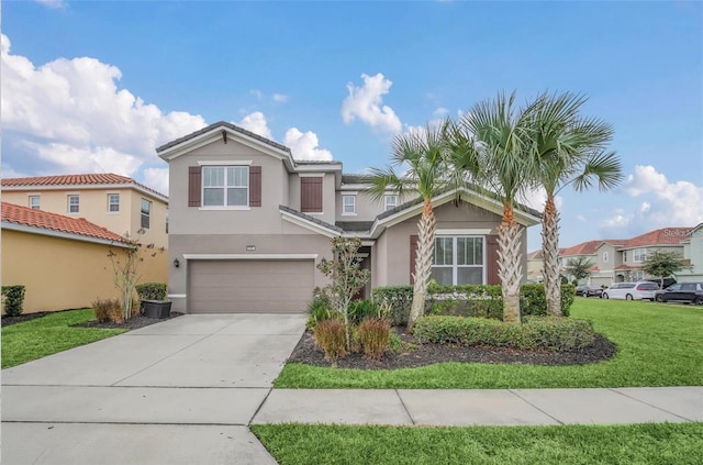 view of front of home featuring stucco siding, a garage, concrete driveway, and a front yard