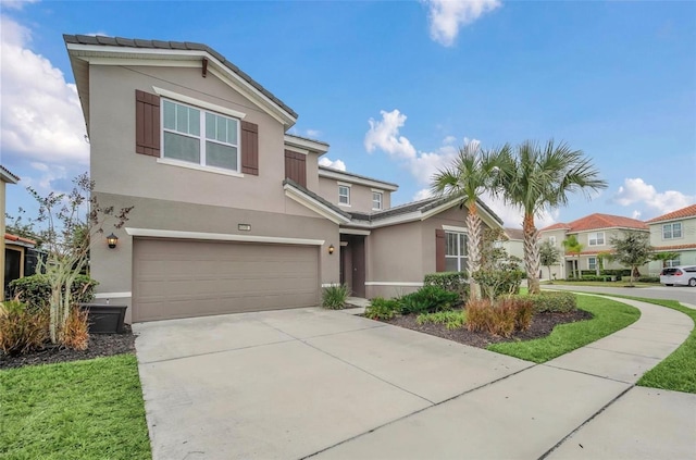 view of front of home with stucco siding, a garage, and driveway