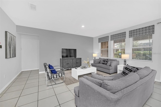 living area featuring recessed lighting, light tile patterned floors, baseboards, and visible vents