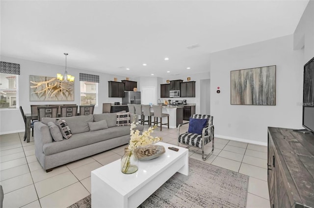 living room featuring light tile patterned floors, baseboards, a notable chandelier, and recessed lighting