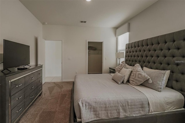 bedroom featuring visible vents, baseboards, and dark carpet