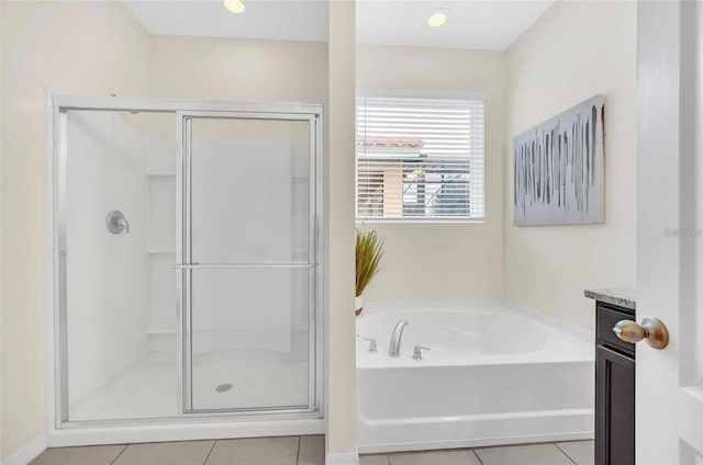 bathroom with tile patterned flooring, a shower stall, recessed lighting, a bath, and vanity