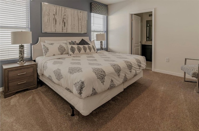 bedroom with connected bathroom, baseboards, and carpet floors