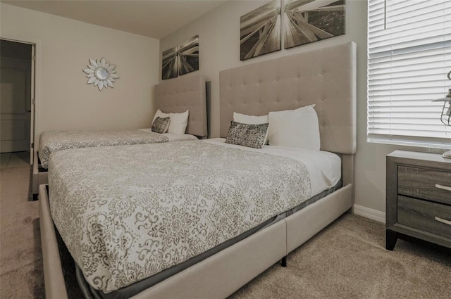 bedroom with baseboards and carpet