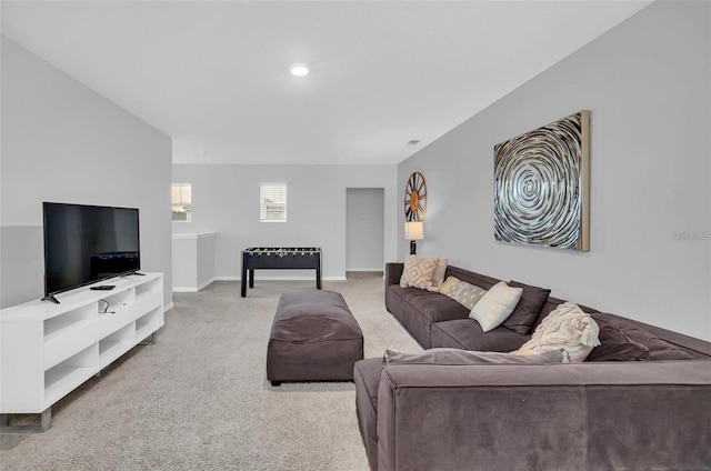 carpeted living area with baseboards