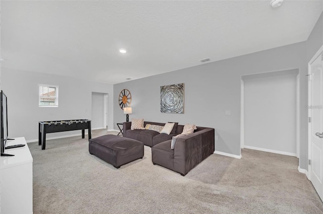 living area with visible vents, baseboards, and carpet floors