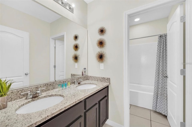 full bathroom featuring double vanity, tile patterned floors, shower / tub combo, and a sink