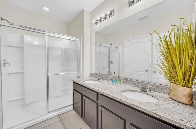 full bathroom with a sink, visible vents, a stall shower, and tile patterned flooring