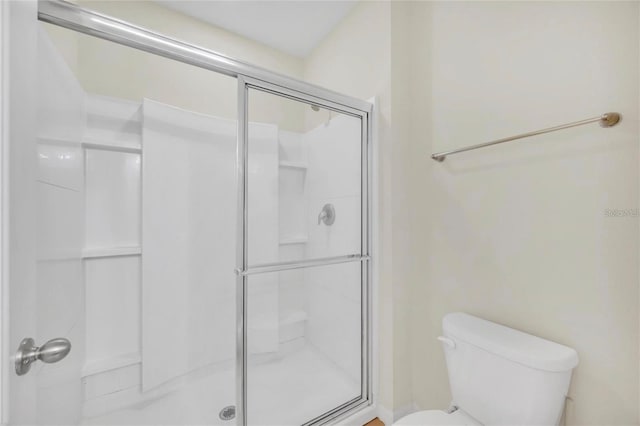 full bathroom with toilet and a stall shower