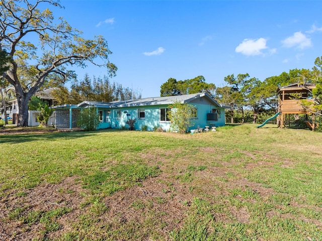 exterior space with a front yard and a playground