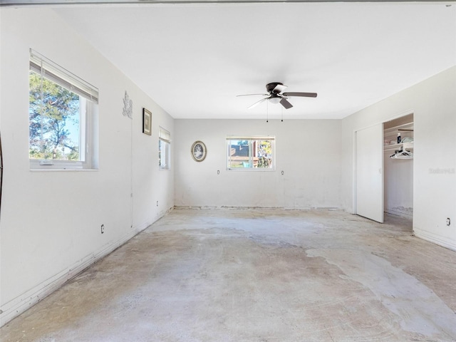 spare room featuring concrete floors and ceiling fan