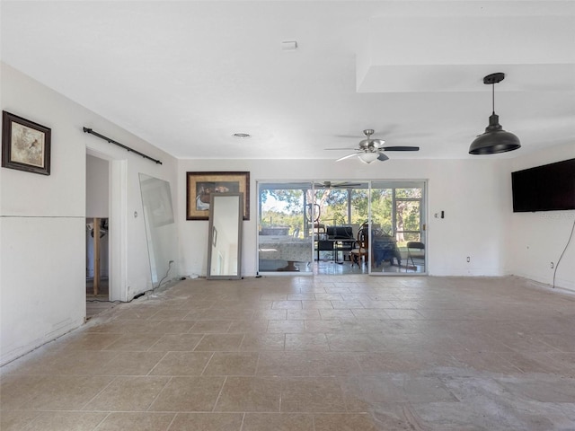 unfurnished living room featuring a ceiling fan