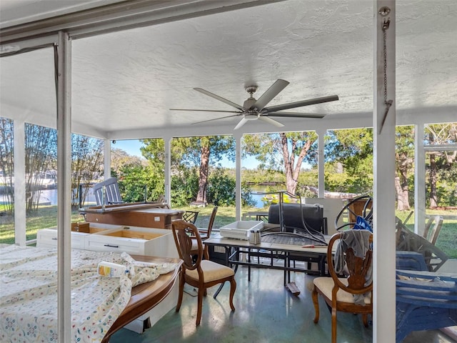 sunroom with a ceiling fan and a wealth of natural light