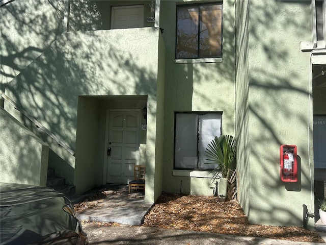 doorway to property with stucco siding