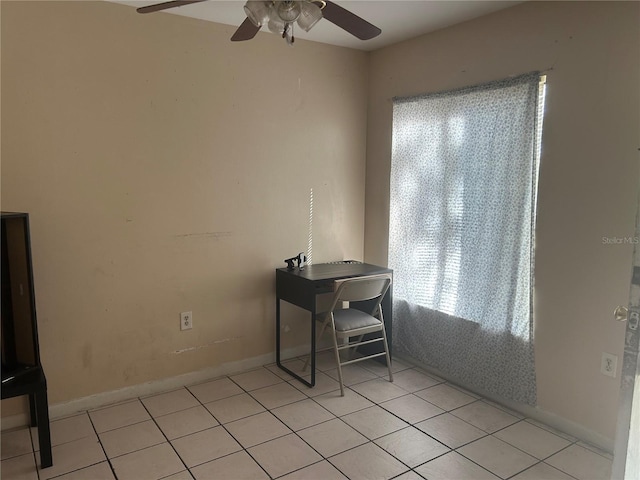 home office with baseboards, light tile patterned flooring, and a ceiling fan