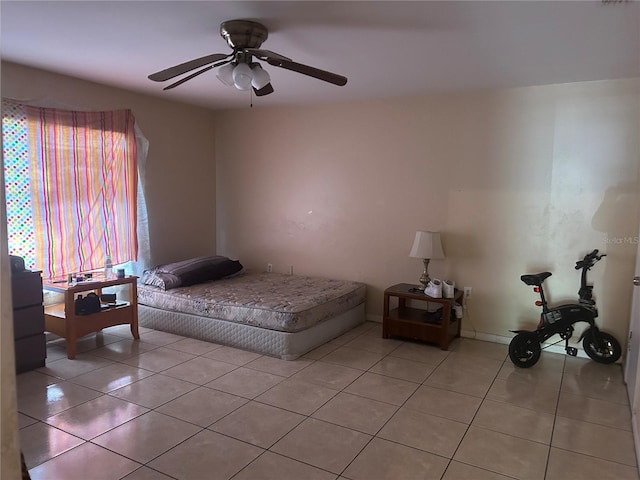 bedroom featuring light tile patterned floors and ceiling fan