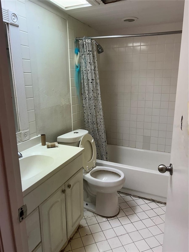 full bathroom with tile patterned flooring, toilet, vanity, and shower / bath combo