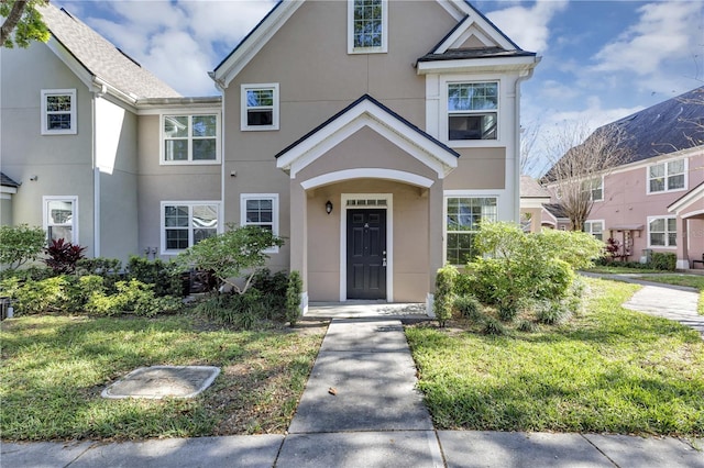 view of front of property featuring stucco siding and a front lawn