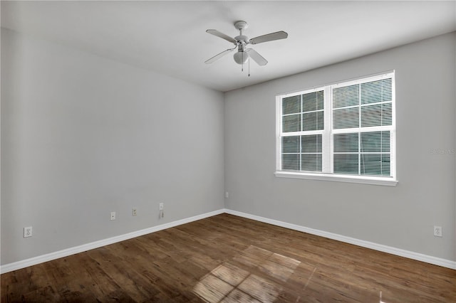 unfurnished room featuring ceiling fan, baseboards, and wood finished floors